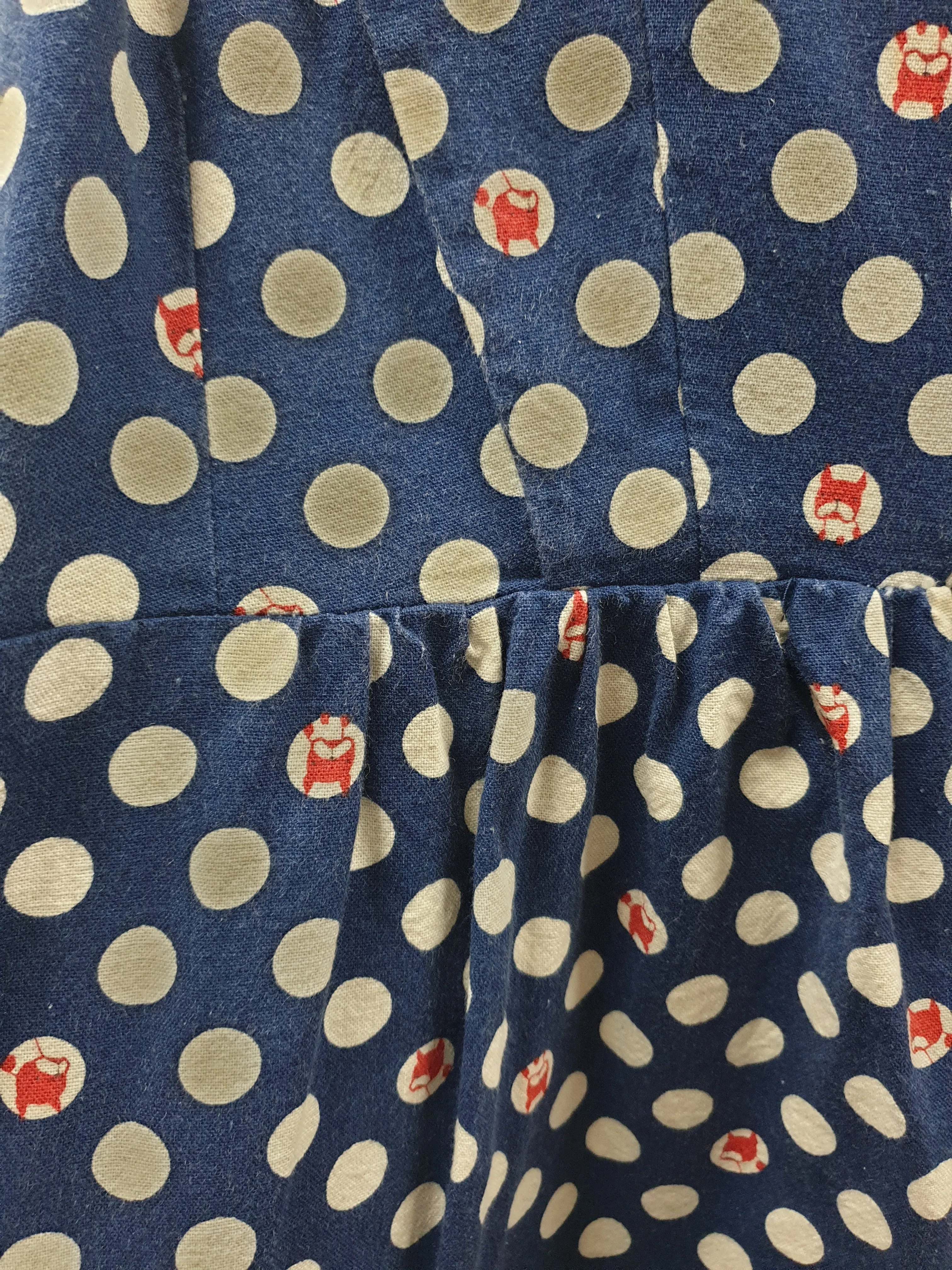 Made590 sleeveless blue and white polka dot dress with dog faces size M (best fits 10)